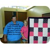 Emily presents her Breastcancer Quilt to Goodiwindi Apex Club for fund raising